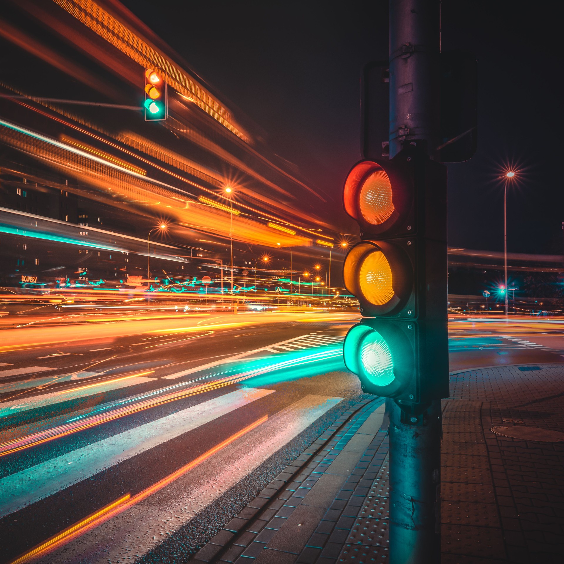 Illuminated Stoplight Against Sky At Night